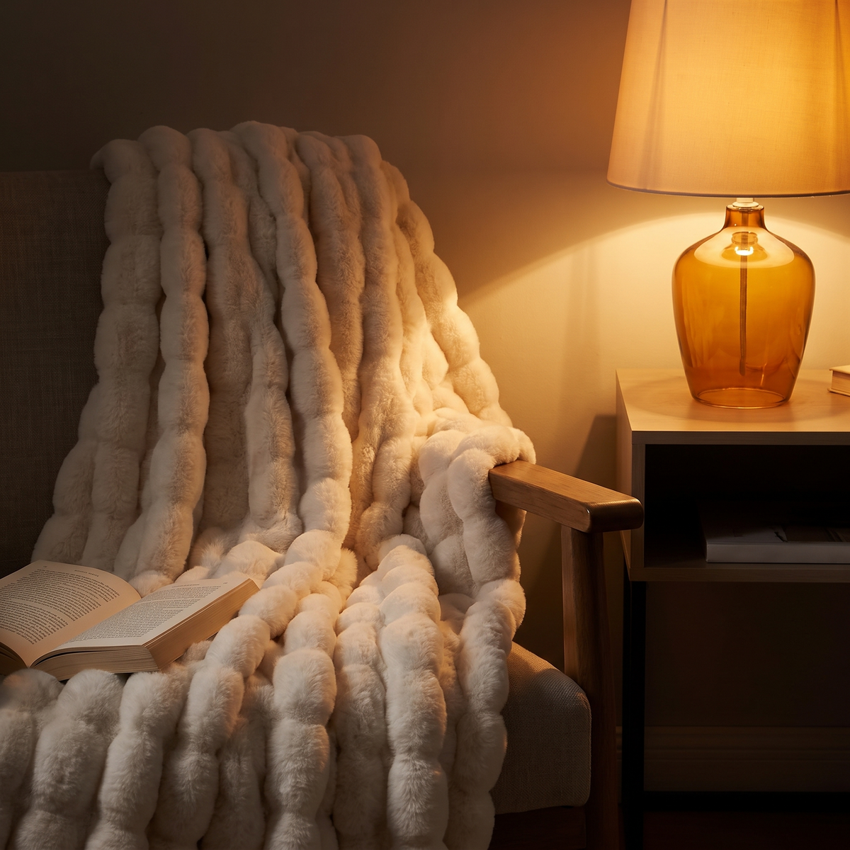 Faux fur throw over a reading chair by lamplight
