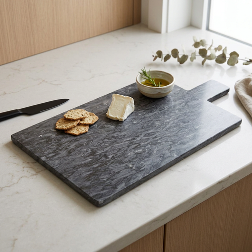 Ashley Paddle-Shaped Black Marble Chopping Board in use
